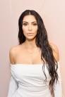 Kim Kardashian shows her epic figure in white dress.
