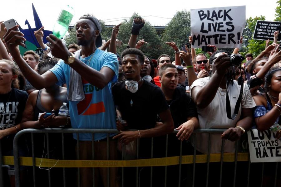 Counter-protesters shout at members of the Ku Klux Klan, who are rallying in opposition to city proposals to remove or make changes to Confederate monuments, in Charlottesville. Ku Klux Klan,Ku Klux Klan rally,Ku Klux Klan rally in Virginia,Confederate monuments