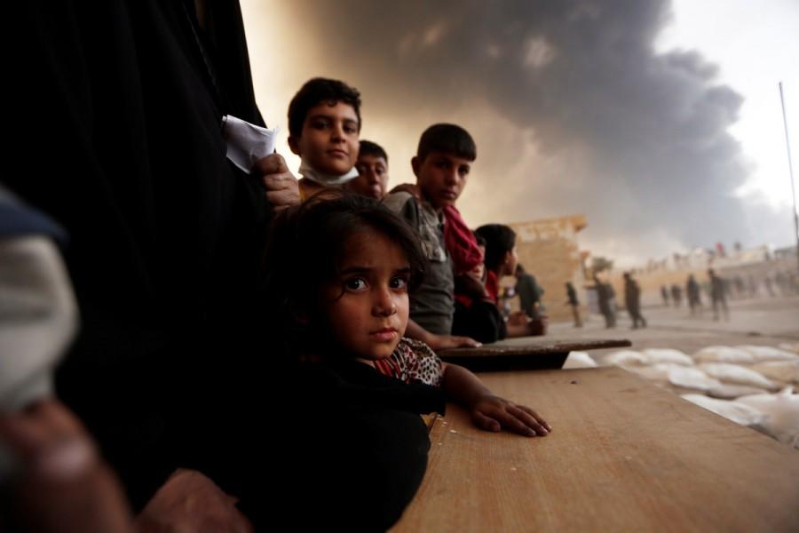 Newly displaced people wait to receive food supplies at a processing center for displaced people In Qayyara, south of Mosul. Battle for Mosul,Mosul,Islamic State in Mosul,Isis Mosul,Mosul Battle,Islamic State