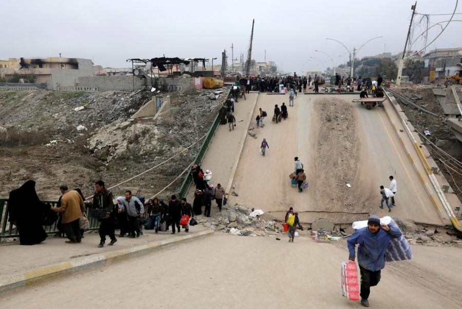 Displaced people, who fled Islamic State militants, cross the bridge in Al-Muthanna neighborhood of Mosul. Battle for Mosul,Mosul,Islamic State in Mosul,Isis Mosul,Mosul Battle,Islamic State