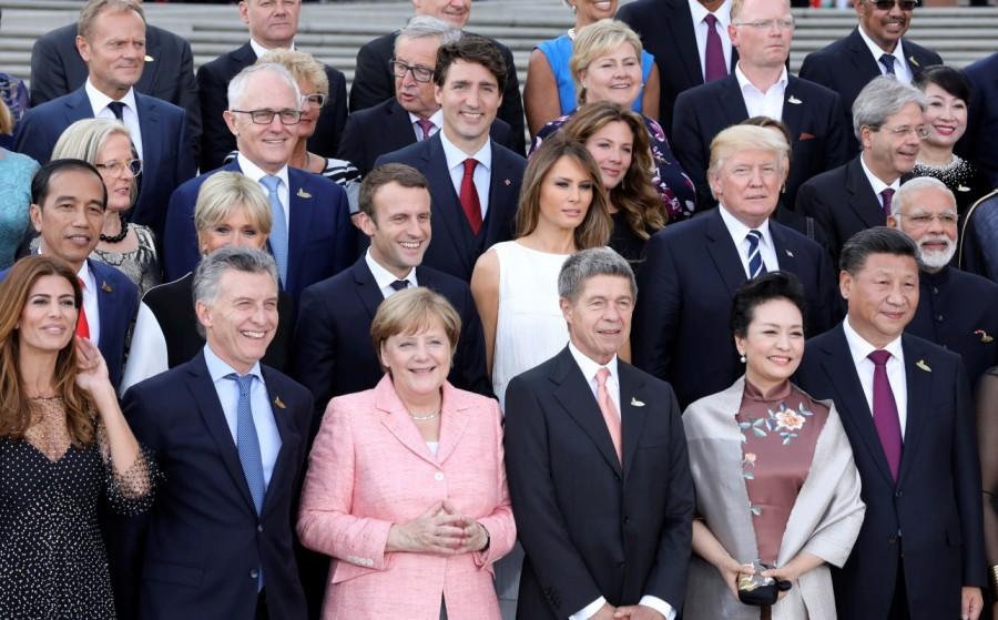 Participants of the G20 summit and their spouses pose for a family photo aroung German Chancellor Angela Merkel (2ndL) and her husband Joachim Sauer (3rdR) at the Elbphilharmonie before attending a concert in Hamburg. First row from L to R: wife of the Argentinia's President Juliana Awada, Argentinia's President Mauricio Macri, wife of China's President Peng Liyuan and China's President Xi Jinping. Second row from L to R: Indonesia's President Joko Widodo, French President's wife Brigitte Macron, French President Emmanuel Macron, US First Lady Melania Trump, US President Donald Trump and India's Prime Minister Narendra Modi. G20 Summit,G20 summit 2017,G20 Summit pics,G20 Summit images,G20 Summit stills,G20 Summit pictures,Argentinia's President Juliana Awada,Argentinia's President Mauricio Macri,French President's wife Brigitte Macron,French President Emmanuel