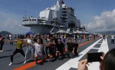 Tourists and residents gathered to catch a glimpse of the massive carrier on its maiden visit to Hong Kong, part of celebrations marking 20 years since the handover of the city from British to Chinese rule.