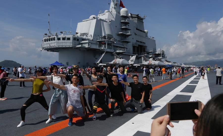 Tourists and residents gathered to catch a glimpse of the massive carrier on its maiden visit to Hong Kong, part of celebrations marking 20 years since the handover of the city from British to Chinese rule. China's first aircraft,Liaoning China's first aircraft carrier,China first aircraft carrier,China aircraft carrier,China military