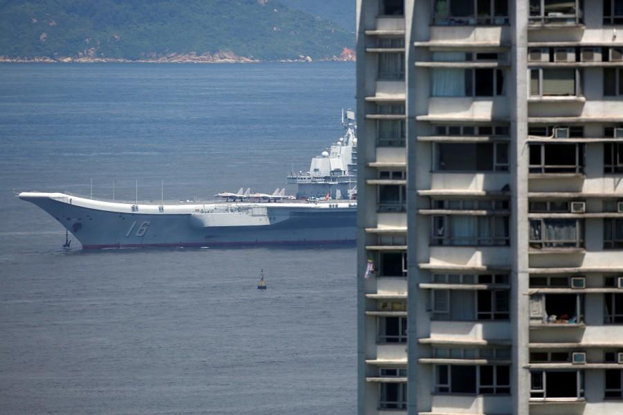The Liaoning was accompanied by two destroyers and other ships from its strike group, with jet fighters and helicopters visible on the flight deck alongside hundreds of crew dressed in white uniforms. China's first aircraft,Liaoning China's first aircraft carrier,China first aircraft carrier,China aircraft carrier,China military