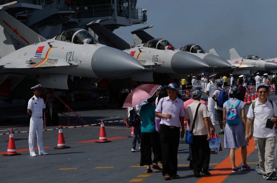 Visitors walk on China's first aircraft carrier Liaoning during an open day at a naval base in Hong Kong. China's first aircraft,Liaoning China's first aircraft carrier,China first aircraft carrier,China aircraft carrier,China military