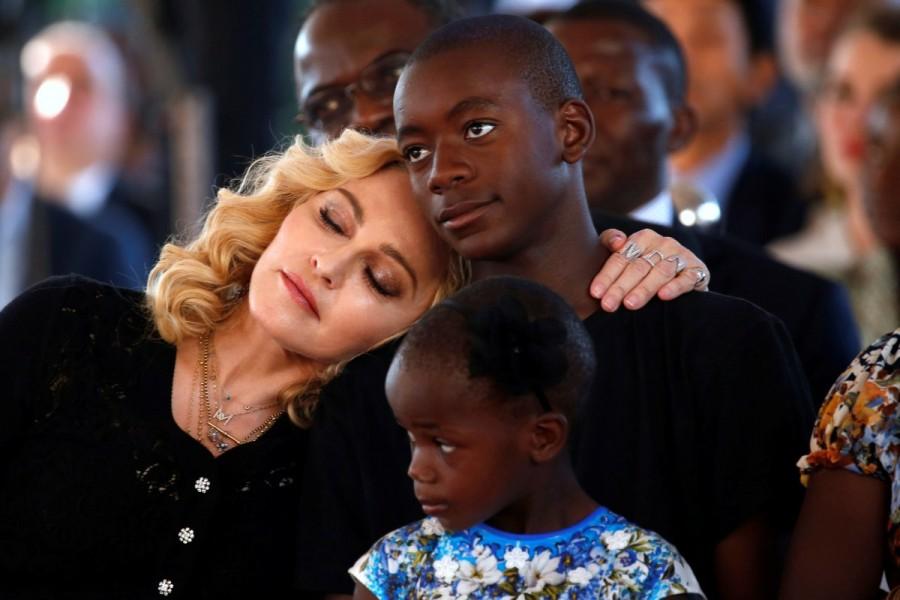 Madonna embraces her adopted son, David Banda ahead of the opening of the Mercy James hospital in Blantyre, Malawi. Madonna,singer Madonna,Madonna sebastian,Madonna opens hospital wing,Madonna opens hospital,Malawi