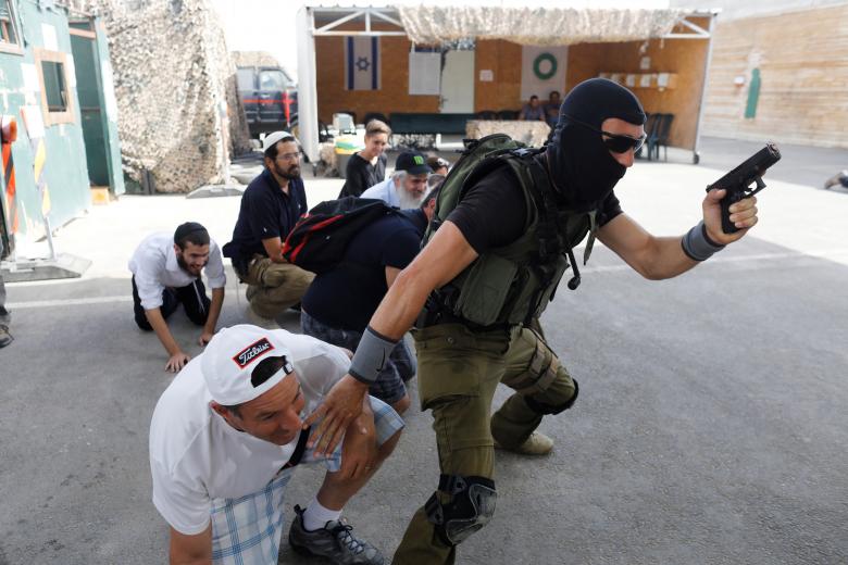 A group of tourists take part in a two hour "boot camp" experience, at "Caliber 3 Israeli Counter Terror and Security Academy " in the Gush Etzion settlement bloc south of Jerusalem in the occupied West Bank. It is part of a counter-terrorism "boot camp" organised by Caliber 3, a company set up by a colonel in the Israeli army reserves. Tourists train,counter-terrorism boot camp,terrorism boot camp,boot camp