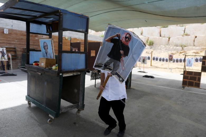A tourist carries a poster as he takes part in a two hour "boot camp". The aim of the mock scenario is to teach foreign visitors how to deal with an attack on a market. Tourists train,counter-terrorism boot camp,terrorism boot camp,boot camp