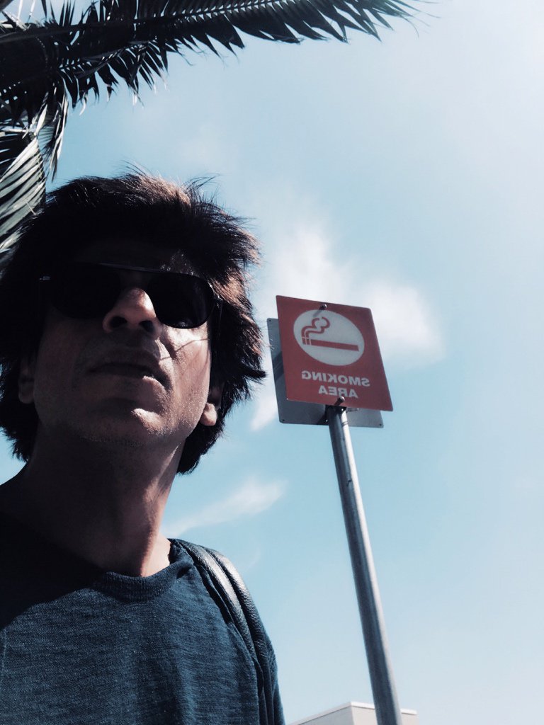 Shah Rukh tweeted a photograph of himself on Tuesday. In the image, the "Dilwale" star can be seen posing in front of a board which reads "Smoking Area". "And I refrained from smoking even though the area sanctioned it! For a break in Los Angeles," Shah Rukh captioned. In "Jab Harry Met Sejal", Shah Rukh will be seen sharing screen space with his former "Rab Ne Bana Di Jodi" co-star Anushka Sharma. Directed by Imtiaz Ali, the film will release on August 4. Shah Rukh Khan,Shah Rukh Khan smoking on vacation,Shah Rukh Khan smoking,Jab Harry Met Sejal