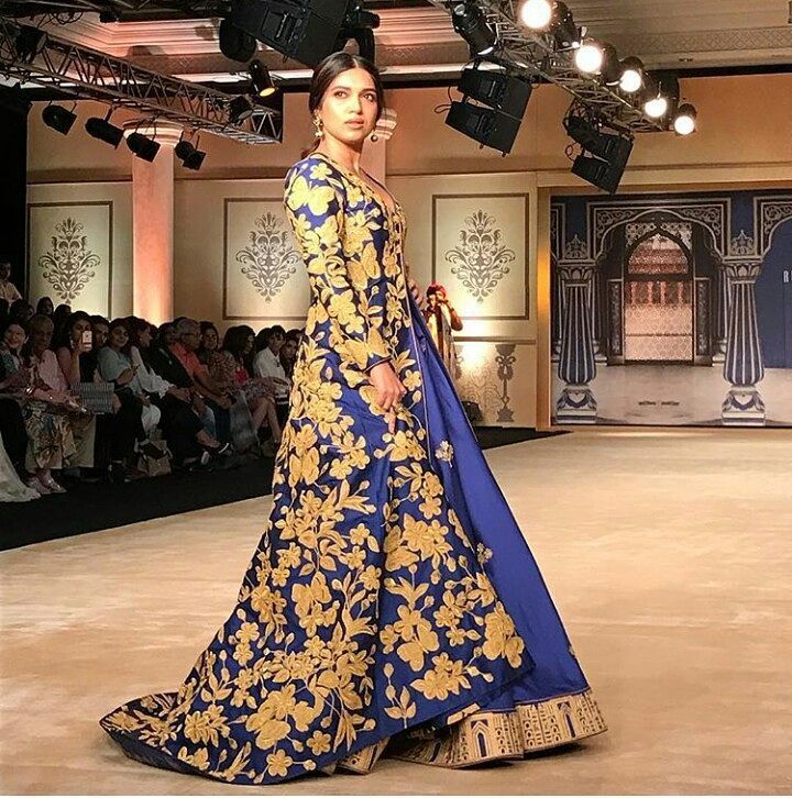 She showcased bold undertones of the Indian monsoon, intricate detailing and beautiful thread work that gently weaved in the magic and mysticism of peacock blue hues. The underplay of carefully used patterns of stripe that break the monotony, use of bold whites, glittering gold's, and the many shades of heavily embroidered silhouettes of aqua blue and green added more volume to her line. Reynu Taandon,Bhumi Pednekar,India Couture Week,India Couture Week 2017,designer Reynu Taandon,Reynu Taandon collection