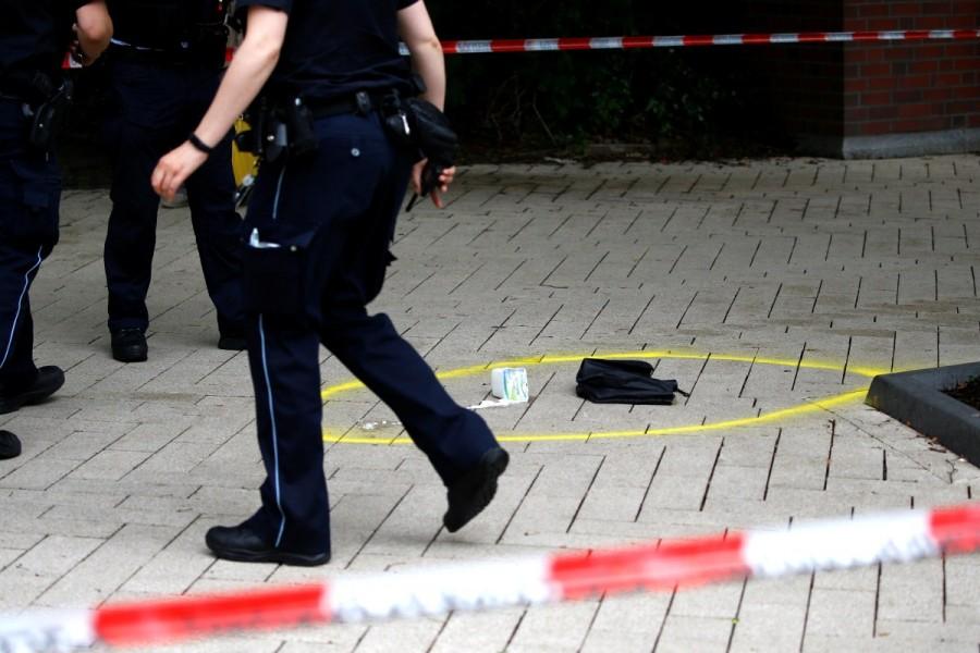 A police officer walks past crime scene after a knife attack in a supermarket in Hamburg, Germany. One person was killed and several were injured in an attack by a lone knifeman in a supermarket in the northern German city on Friday, police said. Hamburg,Hamburg supermarket,Hamburg supermarket attack,Hamburg attack,Knife attack at Hamburg,German city
