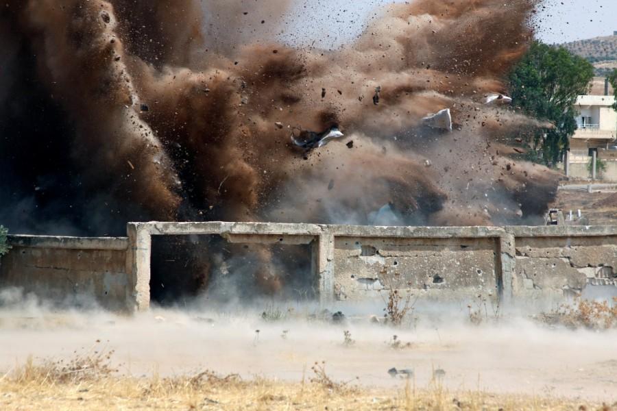 The team, in protective gear, hide behind mounds of soil or buildings. One man holding a trigger attached to the red wire warns his colleagues by radio. Then a shower of dirt and rubble erupts, leaving one fewer unexploded bomb on Deraa's streets. Syria,southwest Syria,cluster bombs,Syria cluster bombs
