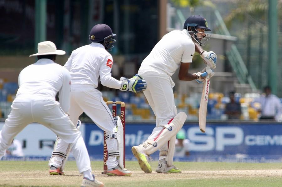 The right-handed duo of Ashwin and Rahane continued to frustrate the Sri Lankans, stealing the odd boundaries and rotating the strike at a good rate to raise their 50-run stand in no time. In his attempt to accelerate after India crossed the psychological 400-run mark, Rahane perished to debutant left-arm spinner Malinda Pushpakumara, smartly stumped by Niroshan Dickwella after facing 222 balls and sending the ball 14 times to the fence. Ravichandran Ashwin,Wriddhiman Saha,Sri Lanka,India vs Sri Lanka,india vs sri lanka live score,India vs Sri Lanka score,India vs Sri Lanka 2017