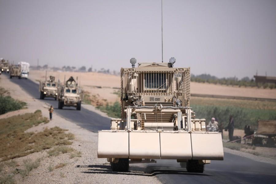 A U.S military demining vehicle leads a convoy on the main road in Raqqa. U.S. forces in Syria,U.S. forces,Syria,U.S. military forces