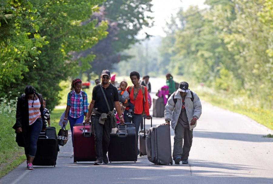 Three families that claimed to be from Burundi walk down Roxham Road to cross into Quebec. Quebec Immigration Minister Kathleen Weil said Thursday that the province is getting as many as 150 refugee claims a day. "We have the necessary experience to deal with this situation ... (but) that pace is stretching our resources," she told reporters. Canada from the U.S.,Canada-U.S. border,U.S. border,Quebec