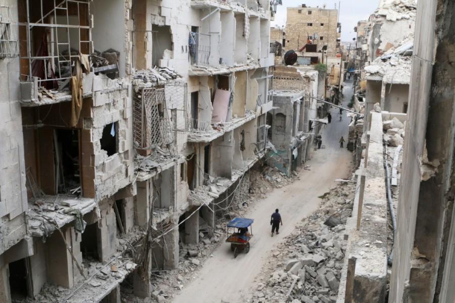 Residents walk near damaged buildings in the rebel held area of Old Aleppo, Syria May 5, 2016. Aleppo's Old City, shelled, burned and shot up during years of fighting in Syria's civil war, can be rebuilt, the local representative of the United Nations cultural body UNESCO said. Aleppo's Old City,Syria’s civil war,United Nations cultural body,UNESCO,Aleppo