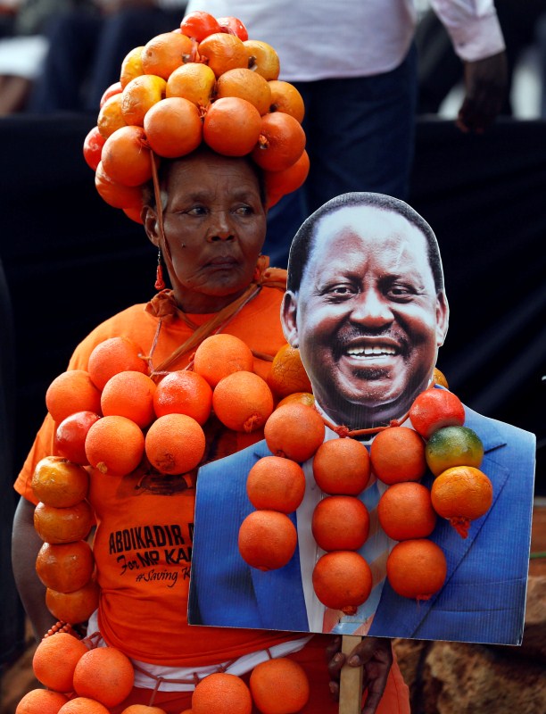 A supporter of Kenyan opposition National Super Alliance (NASA) coalition's presidential candidate Raila Odinga wears oranges and carries his portrait during their final campaign rally at the Uhuru park grounds in Nairobi, Kenya. Kenya,Kenya election,Kenya gears up for election