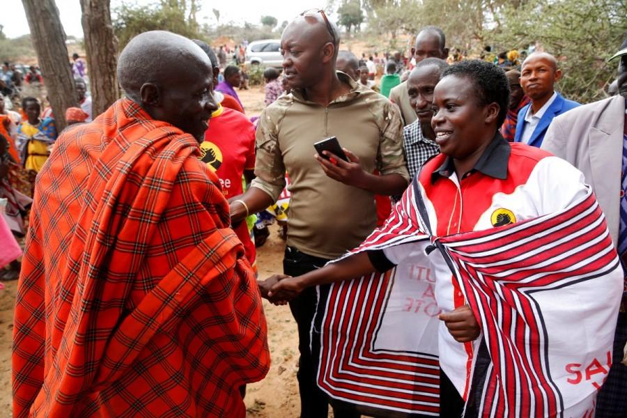 Kenyan lawmaker Sarah Korere (R) greets a supporter during an election campaign rally in the village of Dol Dol in Laikipia County, Kenya. Kenya,Kenya election,Kenya gears up for election