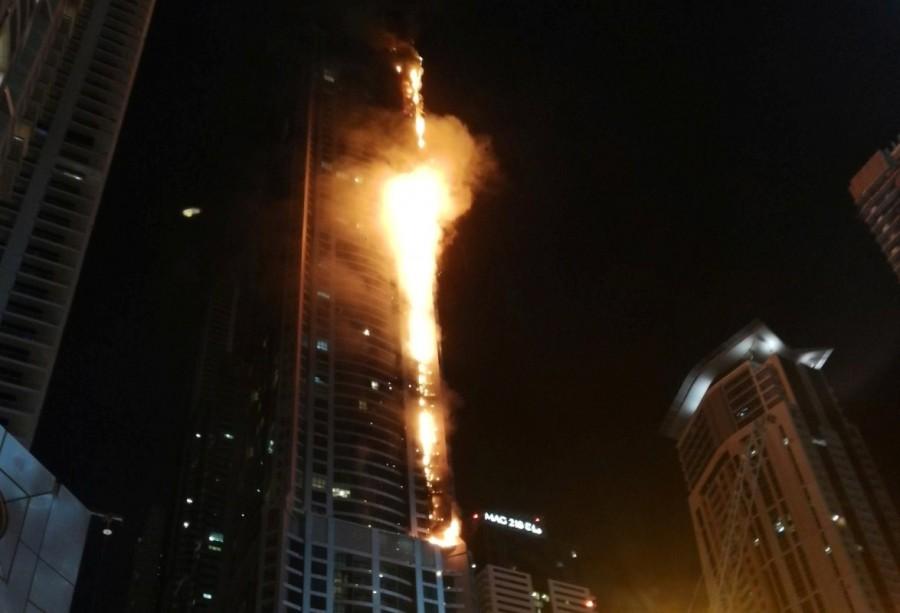 Flames shoot up the sides of the Torch tower residential building in the Marina district, Dubai, United Arab Emirates. Blaze sweeps,Dubai skyscraper,Blaze sweeps through Dubai skyscraper,Dubai,United Arab Emirates