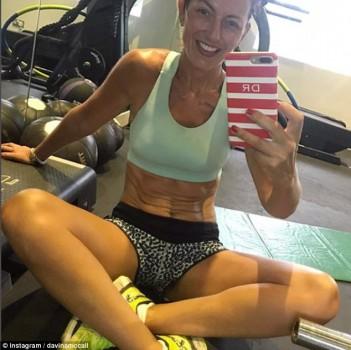 Television presenter Davina McCall flaunts her washboard abs.