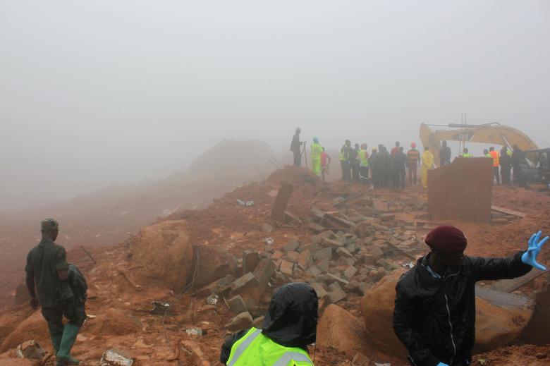 People walk up the mudslide in the mountain town of Regent, Sierra Leone August 15, 2017 in this still image taken from a video. Sierra Leone flooding,Sierra Leone flood,flooding in Sierra Leone,heavy rainfall in Sierra Leone,200 feared dead in Sierra Leone