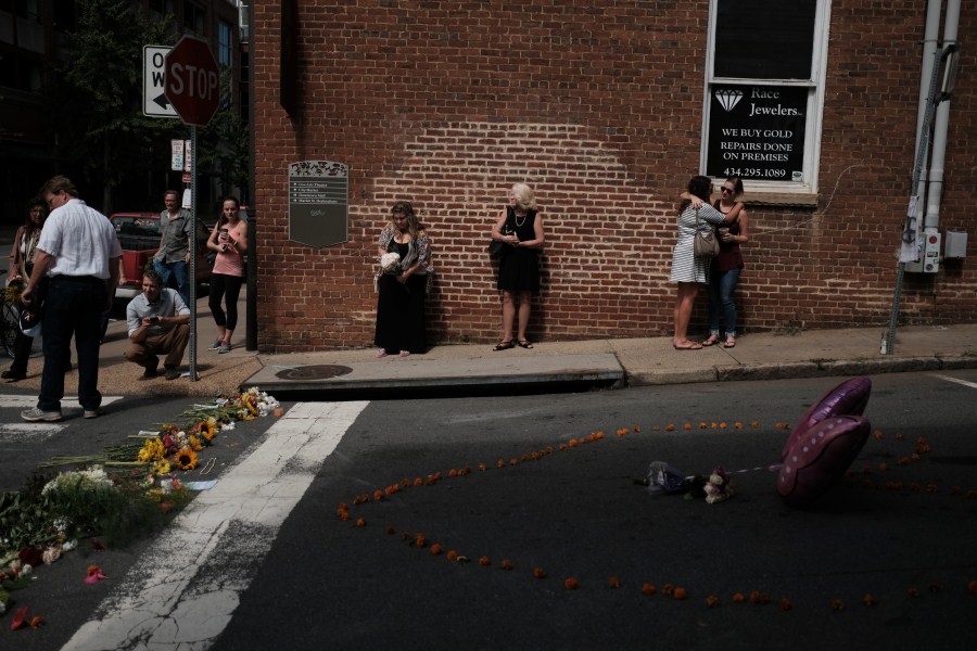 Mourners gather at a makeshift memorial at the scene of where a car plowed into counter-protesters in Charlottesville, Virginia. Charlottesville violence,Aftermath of deadly Charlottesville violence,Charlottesville,Virginia