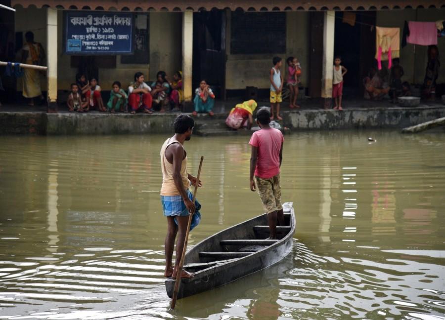 Families take shelter at a school in Baghmari village in Nagaon district, in the northeastern state of Assam, India. Monsoon floods across South Asia,floods across South Asia,monsoon rains in Nepal,Floods in Nepal,Floods in Bangladesh,Floods in India