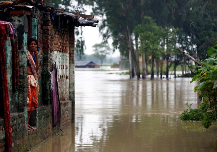 A woman looks out from her house in Janakpur, Nepal. Monsoon floods across South Asia,floods across South Asia,monsoon rains in Nepal,Floods in Nepal,Floods in Bangladesh,Floods in India