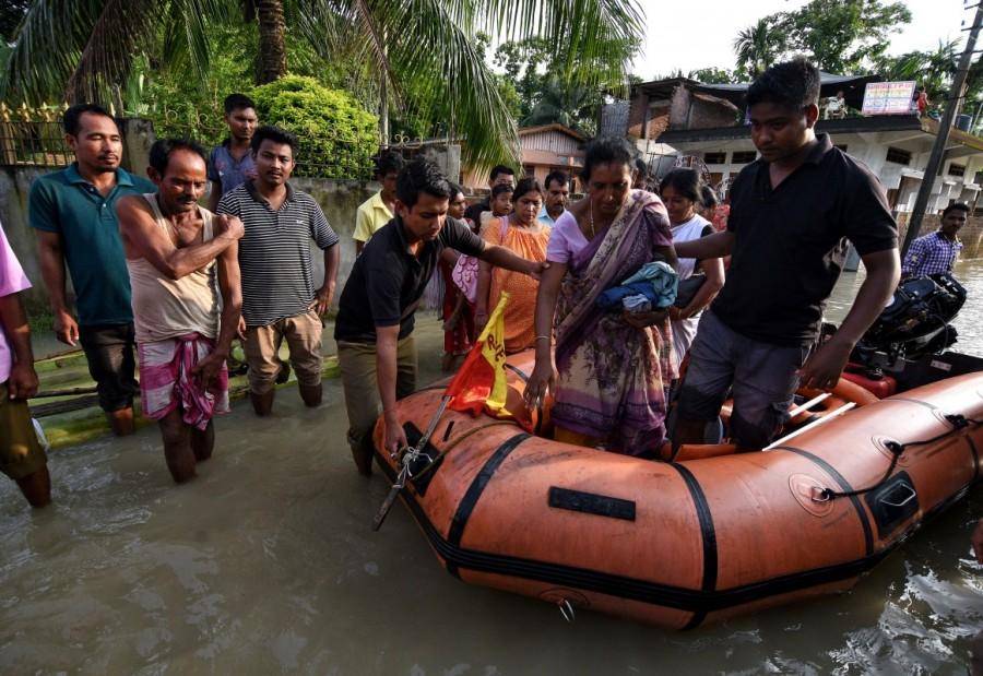 State Disaster Response Force (SDRF) personnel evacuate villagers in Kaliabor area in Nagaon district, in the northeastern state of Assam, India August 15, 2017. Monsoon floods across South Asia,floods across South Asia,monsoon rains in Nepal,Floods in Nepal,Floods in Bangladesh,Floods in India