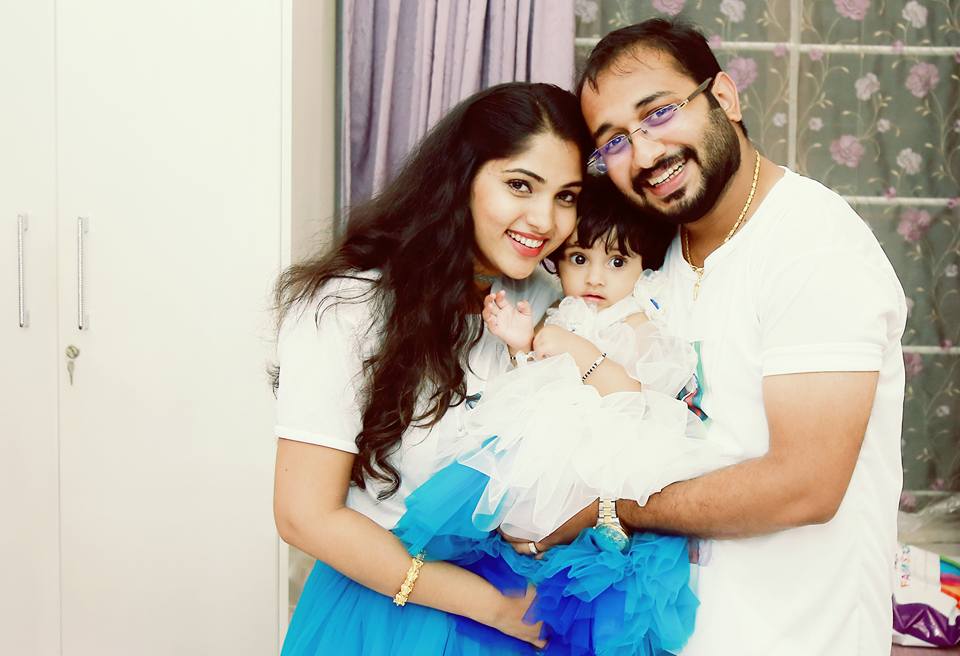 South Indian actress Muktha with her husband Rinku Tomy during the first birthday celebration of their daughter Kanmani. Muktha,Muktha family photos,Muktha daughter,Muktha daughter photos,Muktha rinku tomy,rimi tomy,Muktha daughter first birthday