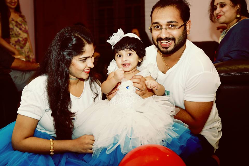 "Just one year ago God reached down and blessed us with a beautiful daughter. We thank Him every day for our special gift. Love you," Muktha wrote on her Facebook page. Muktha,Muktha family photos,Muktha daughter,Muktha daughter photos,Muktha rinku tomy,rimi tomy,Muktha daughter first birthday