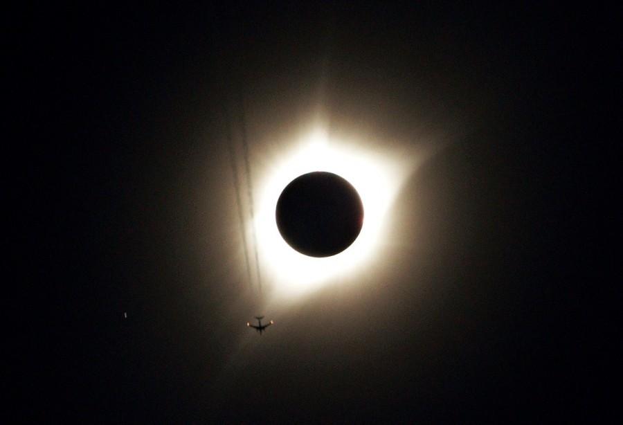 A jet plane flies by the total solar eclipse in Guernsey, Wyoming U.S. August 21, 2017. Solar eclipses,breathtaking photos of solar eclipses,solar eclipses pics,solar eclipses images,solar eclipses stills,solar eclipses around America