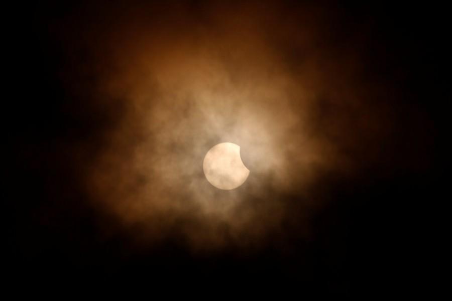 The partial eclipse is obscured by clouds, viewed from the flight deck of the Naval museum ship U.S.S. Yorktown during the Great American Eclipse in Mount Pleasant, South Carolina, U.S. August 21, 2017. Solar eclipses,breathtaking photos of solar eclipses,solar eclipses pics,solar eclipses images,solar eclipses stills,solar eclipses around America