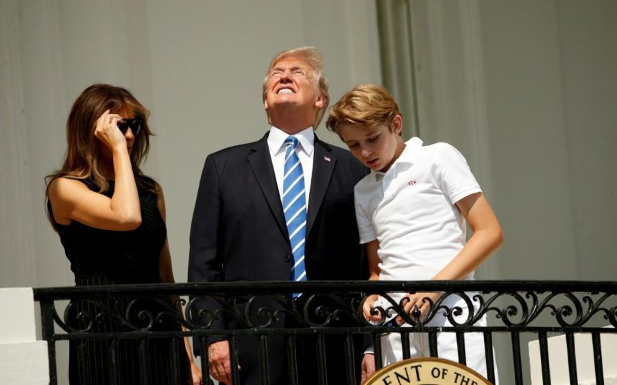 Without his protective glasses on, U.S. President Donald Trump looks up towards the solar eclipse while viewing with his wife Melania and son Barron at the White House in Washington, U.S., August 21, 2017. Solar eclipses,breathtaking photos of solar eclipses,solar eclipses pics,solar eclipses images,solar eclipses stills,solar eclipses around America