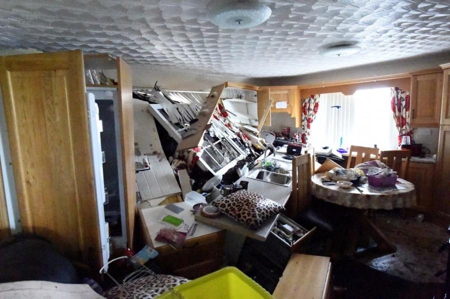 The kitchen of Bernie Kearney's destroyed home is seen, after a landslide carrying a boulder and her car (seen at the kitchen window) came through the house, during torrential rains in Urris, County Donegal, Ireland August 24, 2017. Torrential rains in northwest Ireland, described by the country's weather office as a once-in-a-century event, triggered a landslide that sent a car flying through the wall of a house earlier this week. Bernie Kearney,Irish woman escapes landslide,landslide