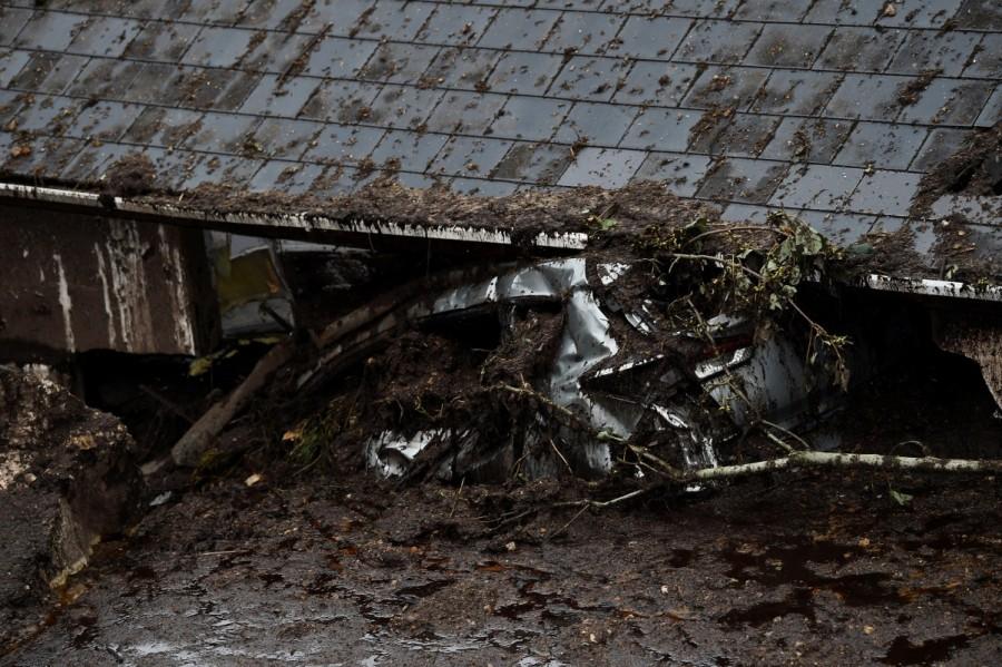 In the light of day, Kearney discovered that the landslide had thrown a boulder against her car, pushing it into her kitchen. The damage was captured in Reuters pictures on Thursday that show her silver hatchback sitting high on a pile of mud and rubble, with its roof touching the eaves of her bungalow. The property has been condemned. Bernie Kearney,Irish woman escapes landslide,landslide