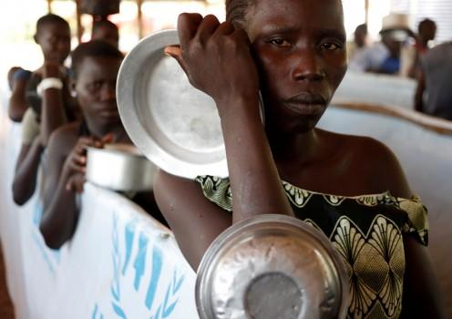 South Sudanese refugees wait in line for food in Omugo refugee settlement camp in northern Uganda.