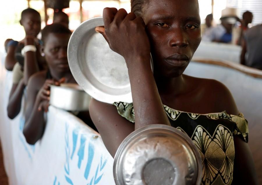 South Sudanese refugees wait in line for food in Omugo refugee settlement camp in northern Uganda. South Sudanese refugees,South Sudanese refugees in Uganda,Uganda,Sudanese refugees