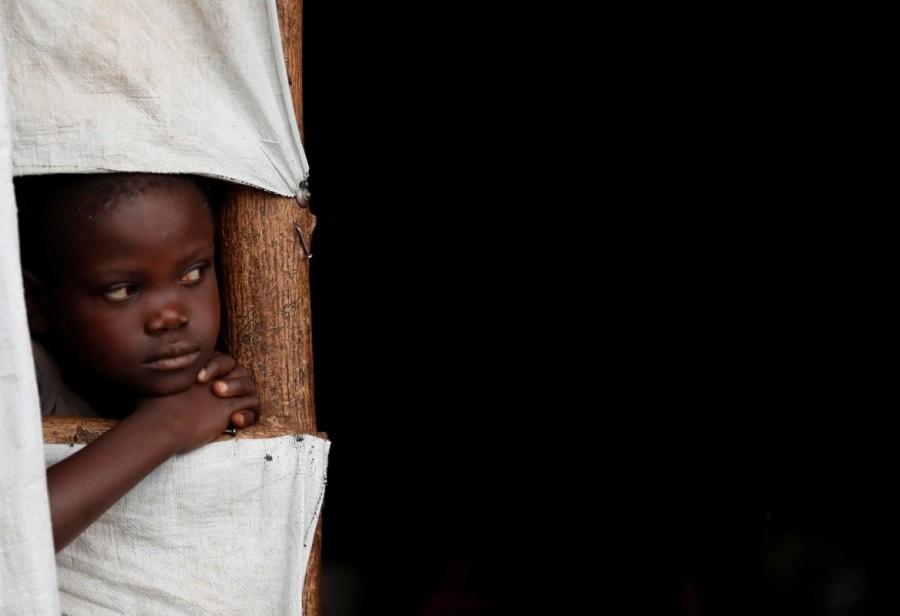 A South Sudanese refugee boy looks out of a transit tent at the Imvepi refugee settlement camp in Arua District, northern Uganda. The number of South Sudanese refugees in Uganda has hit one million as hundreds of desperate families pour across the border every day seeking a haven from the civil war. South Sudanese refugees,South Sudanese refugees in Uganda,Uganda,Sudanese refugees