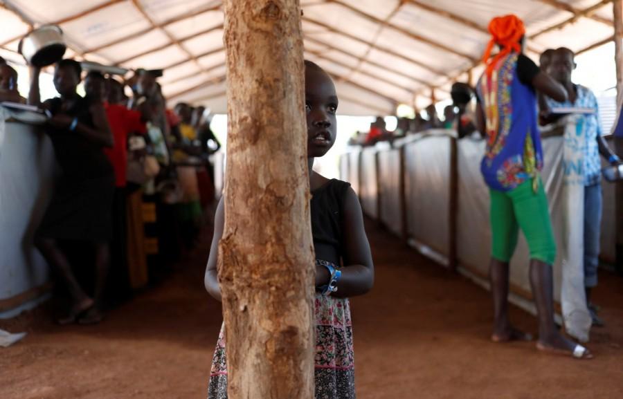 A South Sudanese refugees girl waits for food in Omugo refugee settlement camp in northern Uganda. South Sudanese refugees,South Sudanese refugees in Uganda,Uganda,Sudanese refugees