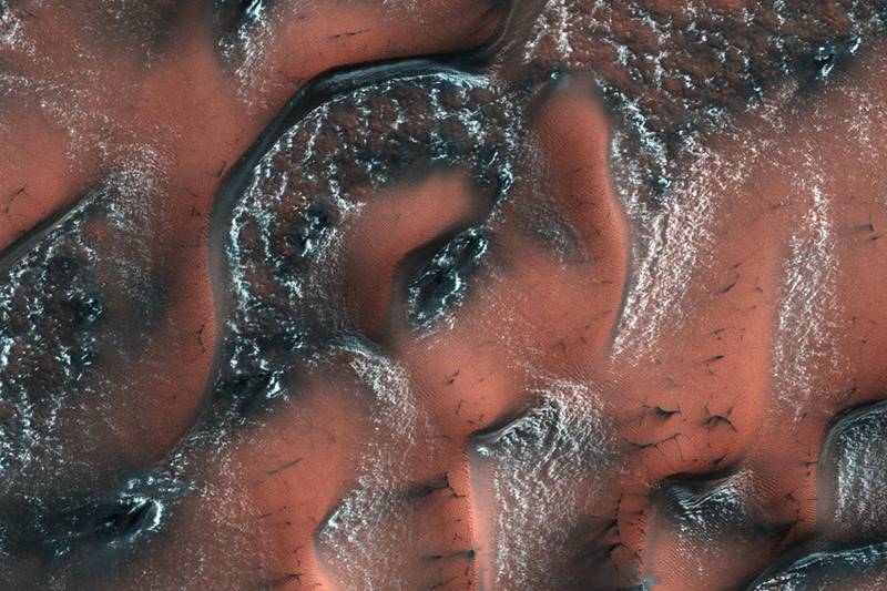 NASA has released a stunning picture of dunes on the surface of Mars with snow and ice on ridges. It was spring in the Northern hemisphere when this image was taken by the High Resolution Imaging Science Experiment (HiRISE) camera on Mars Reconnaissance Orbiter, NASA said. NASA,NASA Mars,snowy dunes,stunning picture of dunes,Mars with snow,Mars with snow and ice on ridges