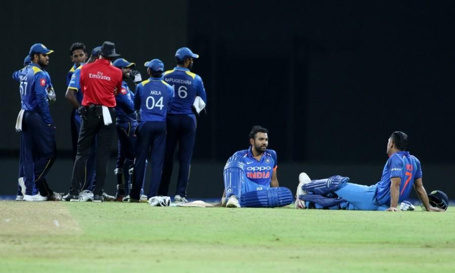 After the resumption of play, the hosts failed to continue the momentum as Siriwardana was removed quickly by Jasprit Bumrah to leave the hosts reeling at 201/8. Lower-order batsmen -- Akila Dananjaya (1), Dushmantha Chameera (6) and Vishwa Fernando (3) -- then tried to pace up the innings but failed in doing so and the hosts were restricted to 217 runs. For India, pacer Bumrah scalped five wickets while Hardik Pandya, Axar Patel and Kedar Jadhav chipped in with one wicket each. India vs Sri Lanka 2017,India vs Sri Lanka,Rohit Sharma,MS Dhoni,India beat Sri Lanka by 6 wickets,India beat Sri Lanka