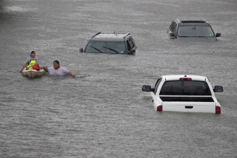 Jesus Rodriguez rescues Gloria Garcia after rain from Hurricane Harvey flooded Pearland, in the outskirts of Houston, Texas, U.S. August 27, 2017. Hurricane Harvey,Hurricane Harvey slams Texas,Texas,Texas Hurricane Harvey,Texas Hurricane