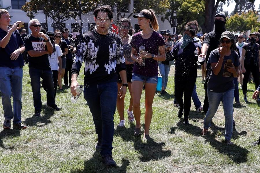 A man is doused with liquid while being chased away by counter-demonstrators. No Marxism,No Marxism rally,Rally Against Hate,No Marxism in America