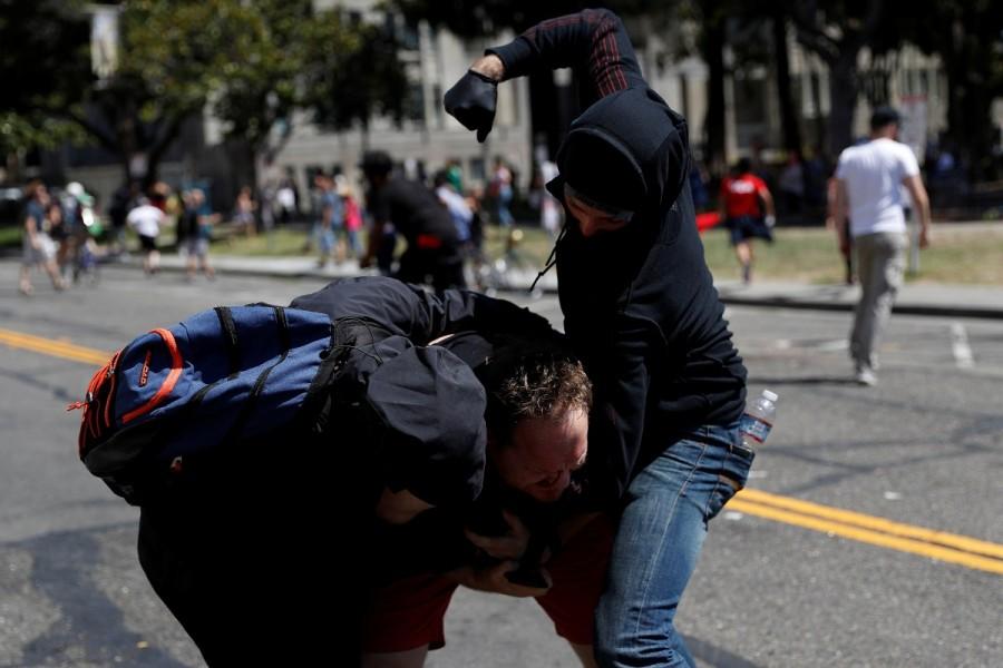 A photographer is attacked by masked demonstrators. No Marxism,No Marxism rally,Rally Against Hate,No Marxism in America
