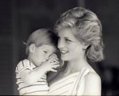 Young Prince Harry tries to hide behind his mother during a morning picture session at Marivent Palace, August 9, 1988.