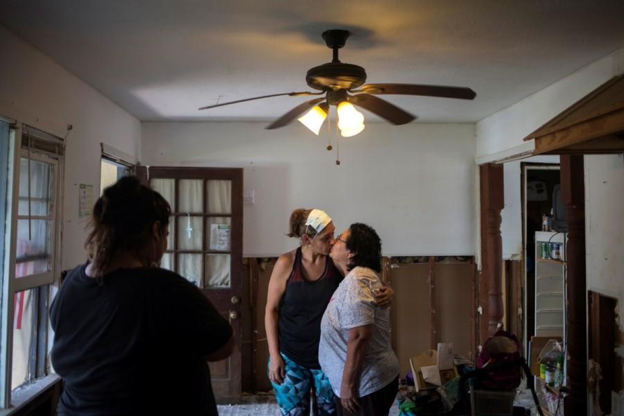 Mariah Castillo watches her mother Roxanne Castillo kiss her mother Dolores Hedger, 68, while salvaging through their family home in the aftermath of Tropical Storm Harvey in Houston, Texas, U.S. September 2, 2017. Evacuees return home,Harvey evacuees return hom,evacuees return hom,Harvey evacuees,Harvey in Houston,Tropical Storm Harvey in Houston