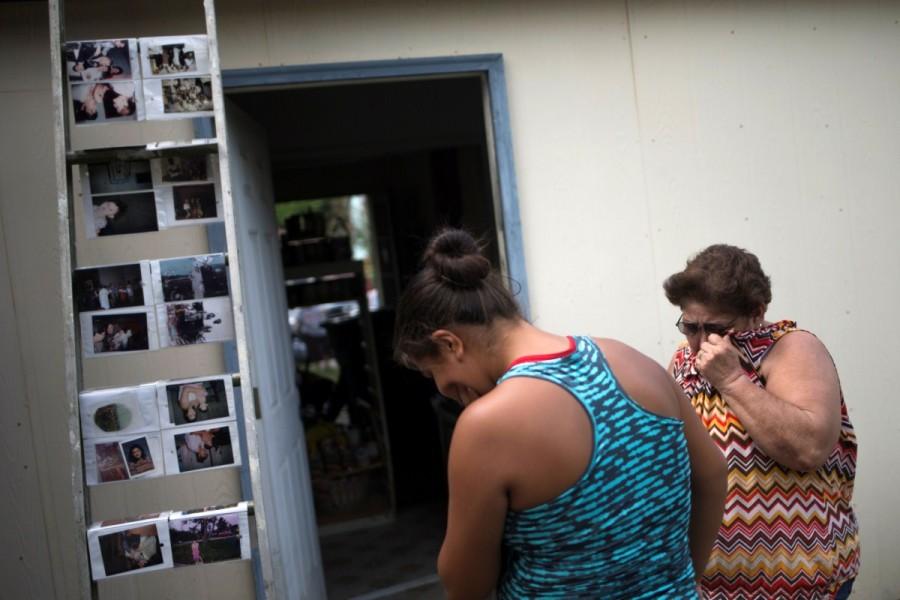 Erlind Trigo and her niece Miriam weep as they look at family photographs which they salvaged from their home in the aftermath of Tropical Storm Harvey in Houston, Texas, U.S. September 2, 2017. Evacuees return home,Harvey evacuees return hom,evacuees return hom,Harvey evacuees,Harvey in Houston,Tropical Storm Harvey in Houston