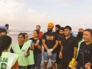 Actor Randeep Hooda was seen with members of NGO Afraz cleaning up the Juhu beach here on Wednesday morning -- a day after Ganeshotsav immersions. In a series of photographs, the "Highway" actor is seen sporting a saffron coloured turban paired with a black T-shirt and blue jeans while cleaning up the beach.