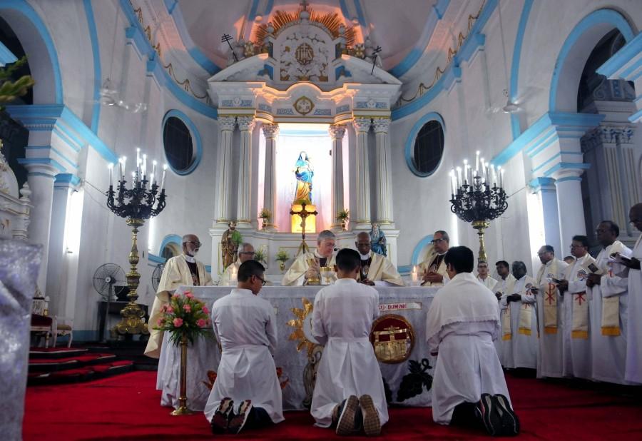 Vatican's ambassador to India, Giambattista Diquattro (C) led a Mass and inaugurates a bronze statue in the church of Mother Teresa carrying a child at a cathedral in Kolkata. Mother Teresa,saint Mother Teresa,Mother Teresa bronze statue,Mother Teresa statue